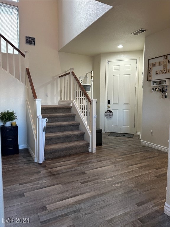 foyer with dark hardwood / wood-style floors