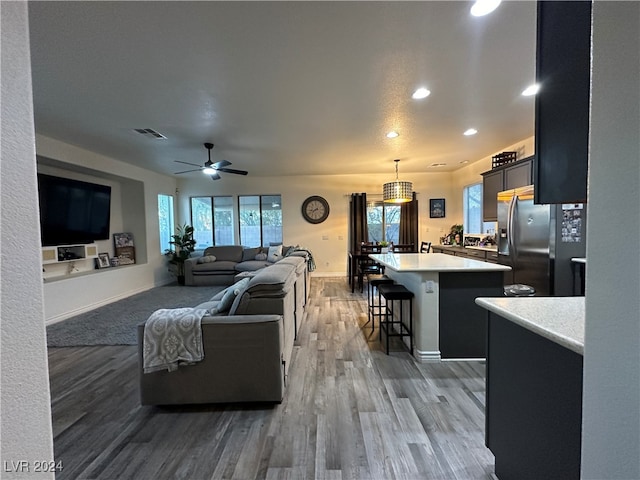 living room featuring dark hardwood / wood-style floors and ceiling fan