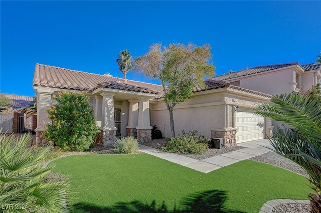 mediterranean / spanish-style home featuring a front yard and a garage