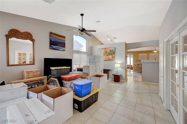 living room featuring ceiling fan, light tile patterned floors, high vaulted ceiling, and french doors