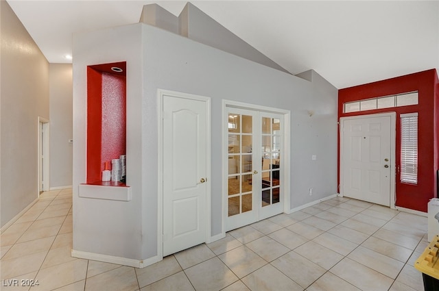 tiled foyer with french doors and vaulted ceiling