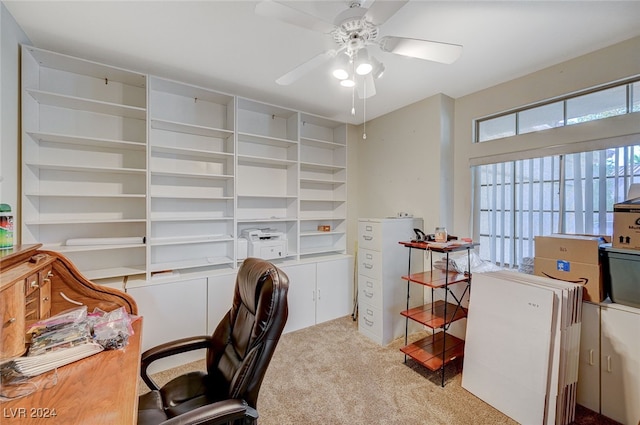 home office with ceiling fan and light carpet