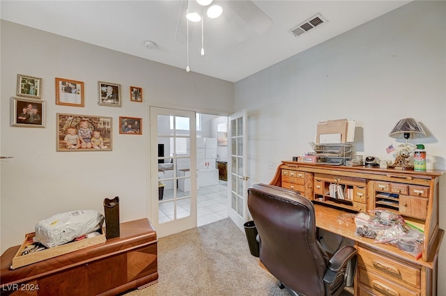 office space with french doors, light colored carpet, and ceiling fan