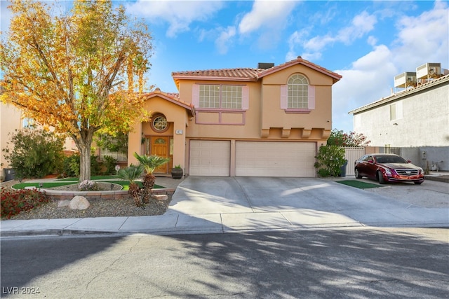 mediterranean / spanish home featuring a garage