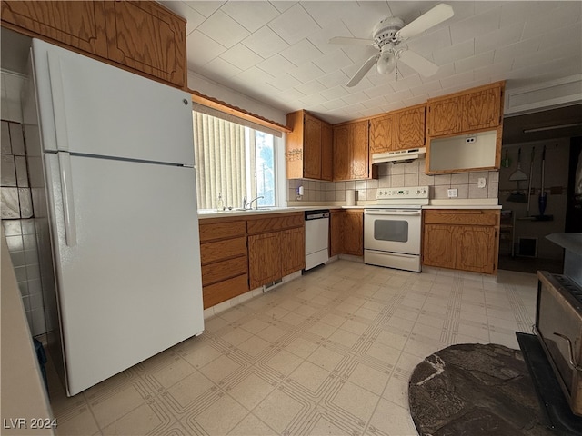 kitchen featuring ceiling fan, sink, white appliances, and backsplash