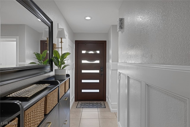 entryway with light tile patterned flooring