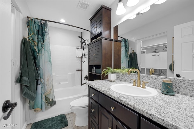 full bathroom with shower / bath combo, vanity, toilet, and tile patterned floors