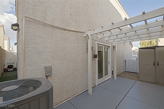 view of patio / terrace featuring a pergola, a storage unit, and central air condition unit