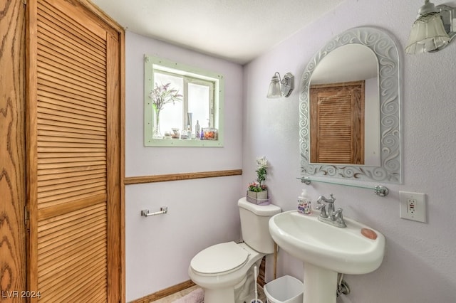 bathroom featuring sink and toilet