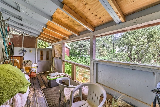 sunroom / solarium with lofted ceiling with beams and a wealth of natural light