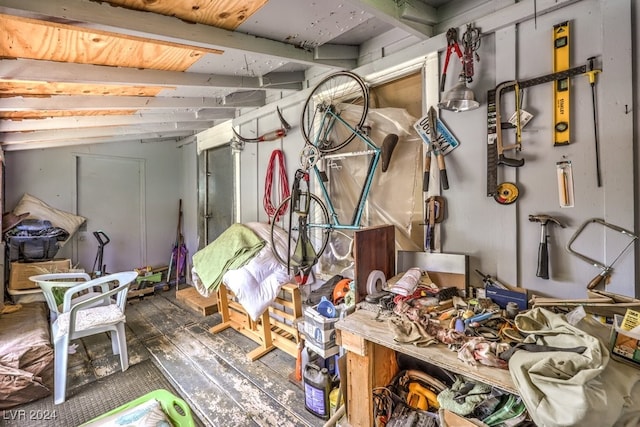 interior space featuring a workshop area and vaulted ceiling