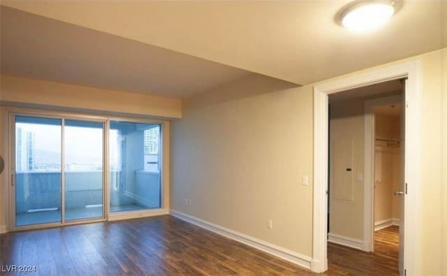 empty room featuring dark hardwood / wood-style flooring