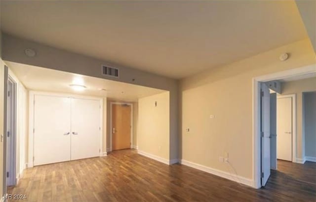 unfurnished room featuring dark hardwood / wood-style floors