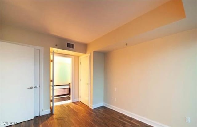 unfurnished bedroom with dark wood-type flooring