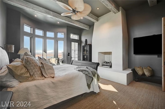 bedroom with beamed ceiling, a high ceiling, carpet floors, and ceiling fan