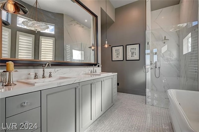 bathroom featuring plenty of natural light, vanity, and independent shower and bath