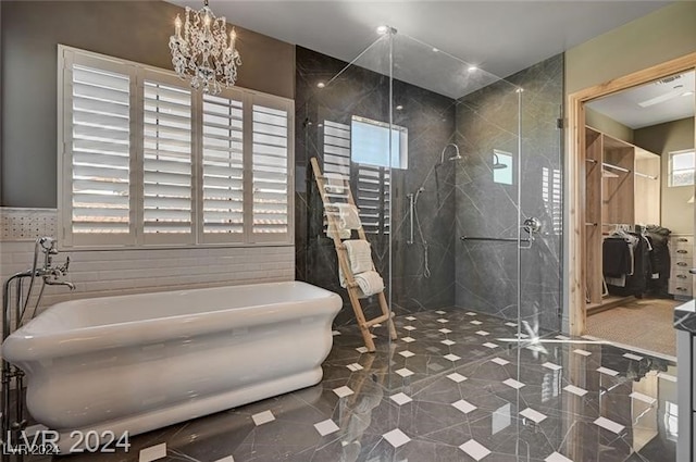 bathroom with plus walk in shower and an inviting chandelier