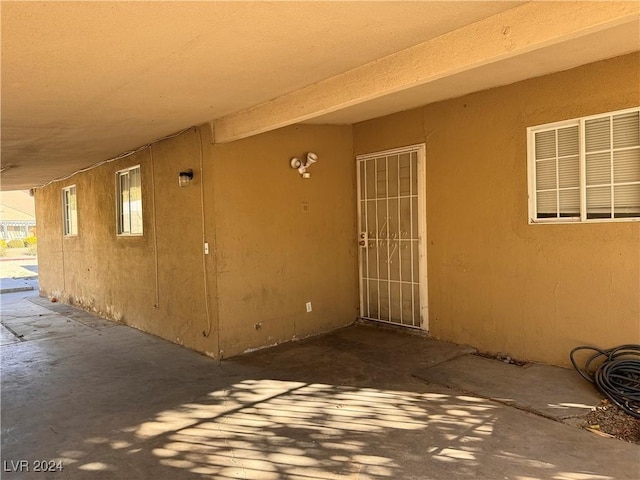 view of exterior entry with a patio