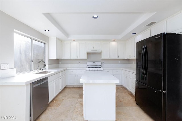 kitchen featuring a kitchen island, dishwasher, sink, a raised ceiling, and black fridge