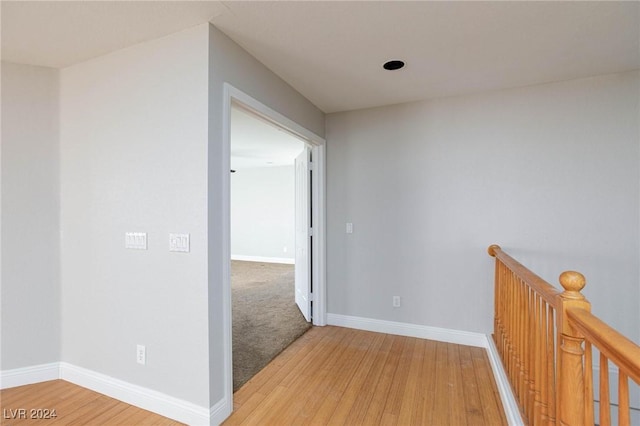 hallway with hardwood / wood-style floors