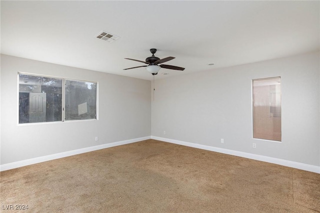 empty room with ceiling fan and carpet flooring