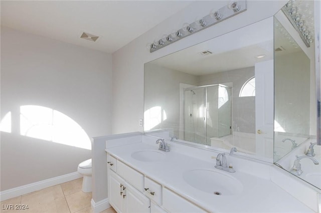 bathroom featuring walk in shower, vanity, toilet, and tile patterned flooring