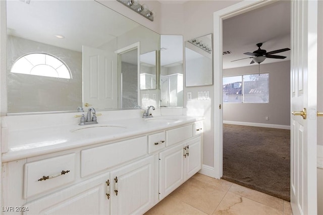 bathroom with ceiling fan, a healthy amount of sunlight, tile patterned flooring, and vanity