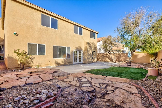 back of property featuring a patio area and french doors