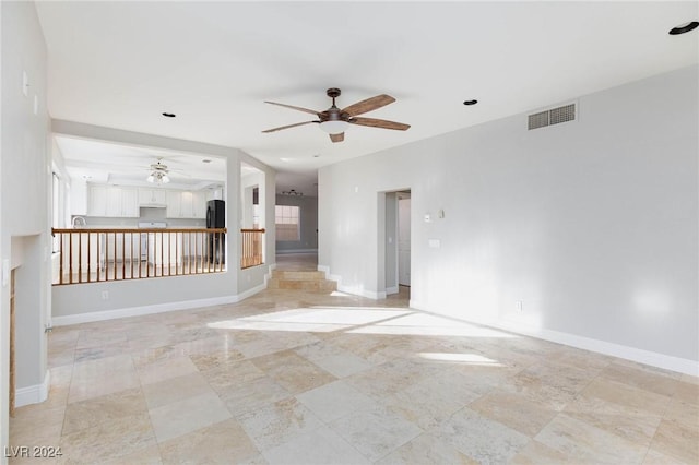 unfurnished living room featuring ceiling fan