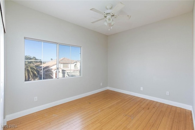 spare room featuring ceiling fan and light hardwood / wood-style flooring