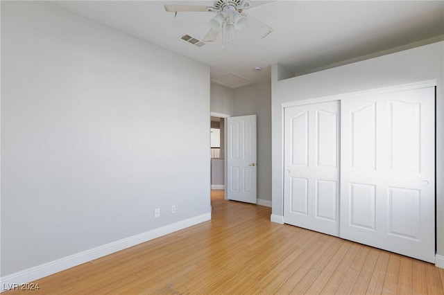 unfurnished bedroom with ceiling fan, light hardwood / wood-style floors, and a closet