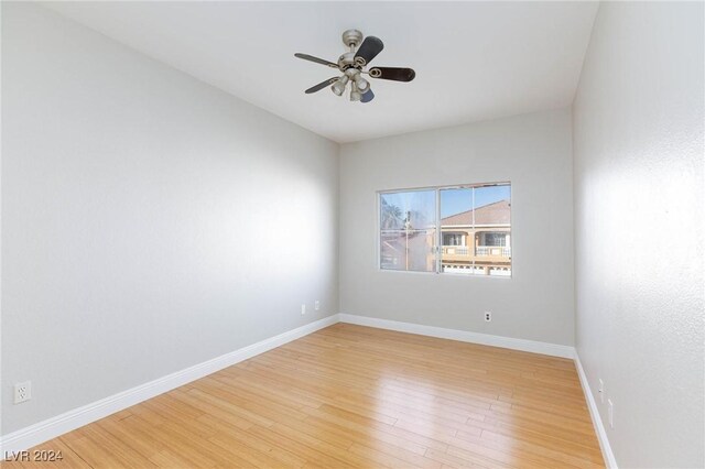 empty room with ceiling fan and light wood-type flooring