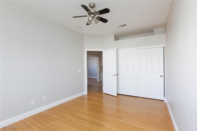 unfurnished bedroom with ceiling fan, light hardwood / wood-style floors, and a closet