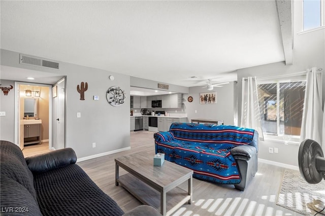 living room with plenty of natural light, visible vents, and wood finished floors