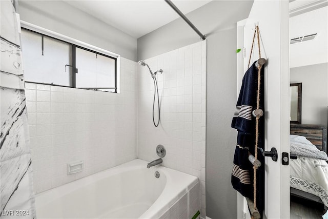 ensuite bathroom featuring ensuite bath, visible vents, and shower / bath combination with curtain