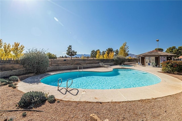 view of swimming pool featuring a fenced in pool, a patio area, and fence