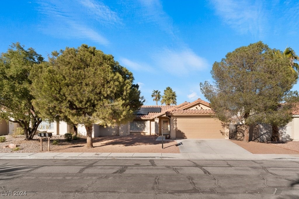 view of front of home with solar panels and a garage