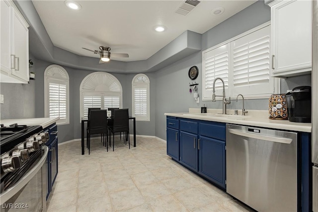 kitchen with light countertops, visible vents, appliances with stainless steel finishes, a sink, and blue cabinets