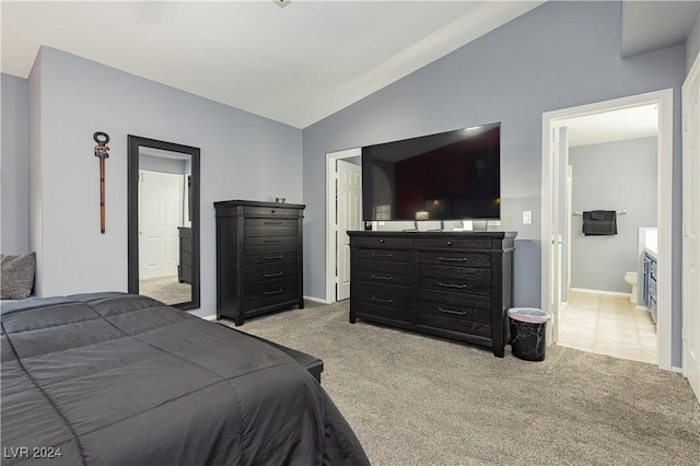 bedroom featuring connected bathroom, baseboards, vaulted ceiling, and carpet flooring