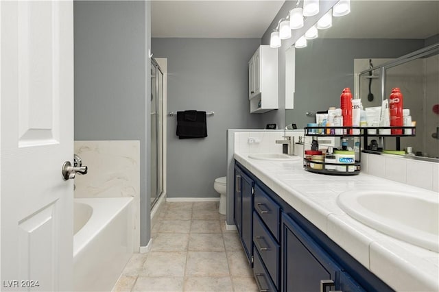 full bathroom featuring double vanity, a sink, a shower stall, a bath, and tile patterned floors