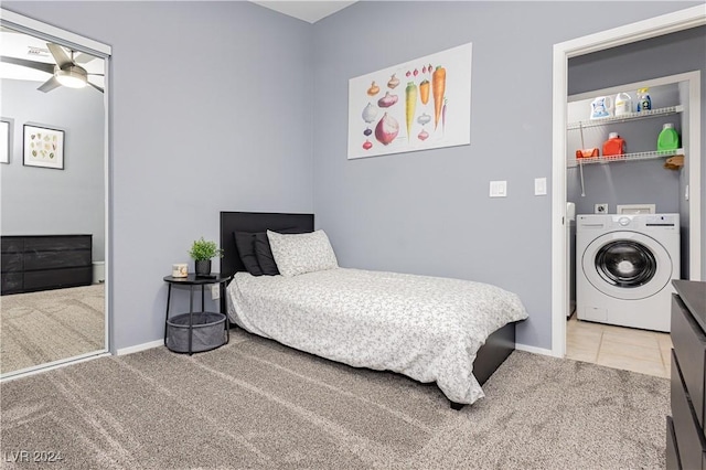 tiled bedroom featuring carpet floors, washer / dryer, and baseboards