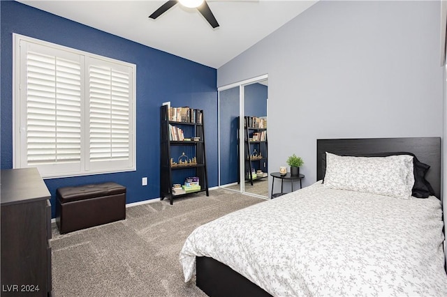 carpeted bedroom with lofted ceiling, ceiling fan, a closet, and baseboards