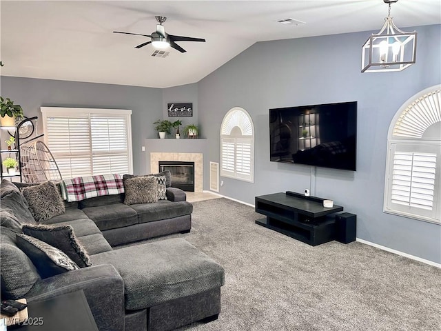 living area with lofted ceiling, carpet, a fireplace, and a wealth of natural light