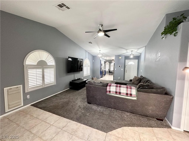 tiled living room with baseboards, visible vents, a ceiling fan, lofted ceiling, and carpet floors