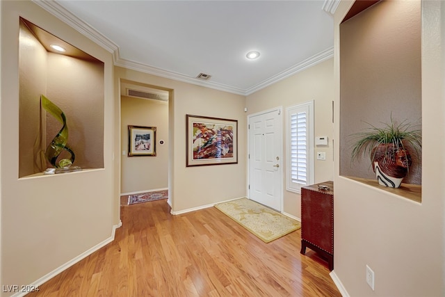 entrance foyer featuring light hardwood / wood-style flooring and ornamental molding