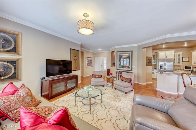 living room with light hardwood / wood-style floors and ornamental molding