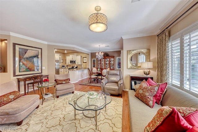 living room with light hardwood / wood-style flooring, plenty of natural light, and ornamental molding