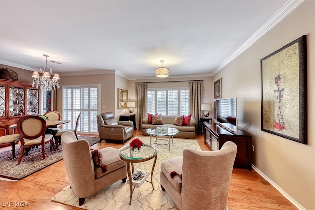 living room featuring a healthy amount of sunlight, an inviting chandelier, crown molding, and light hardwood / wood-style flooring