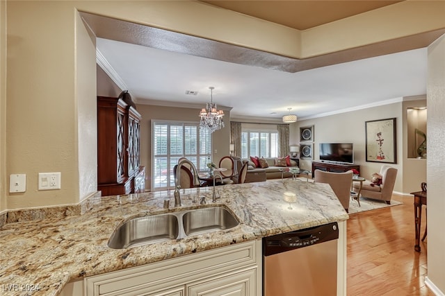 kitchen featuring sink, stainless steel dishwasher, cream cabinetry, light hardwood / wood-style floors, and light stone counters