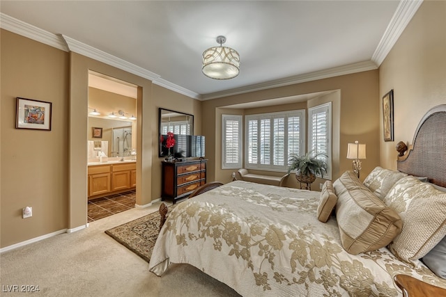 carpeted bedroom with ensuite bathroom and crown molding